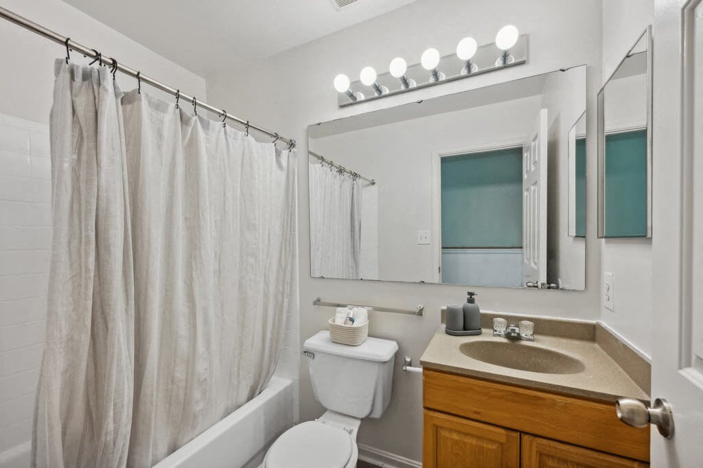 a bathroom with a shower and a sink and a toilet